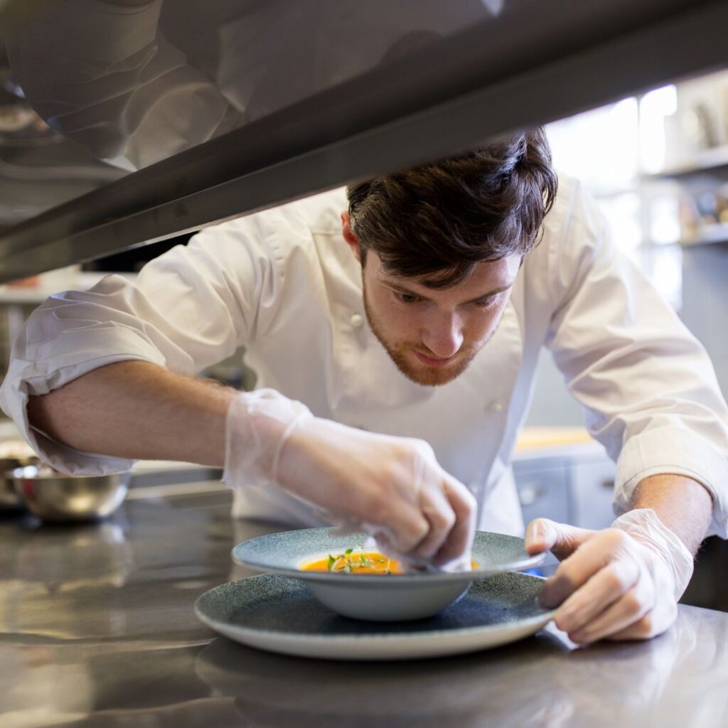 man plating food