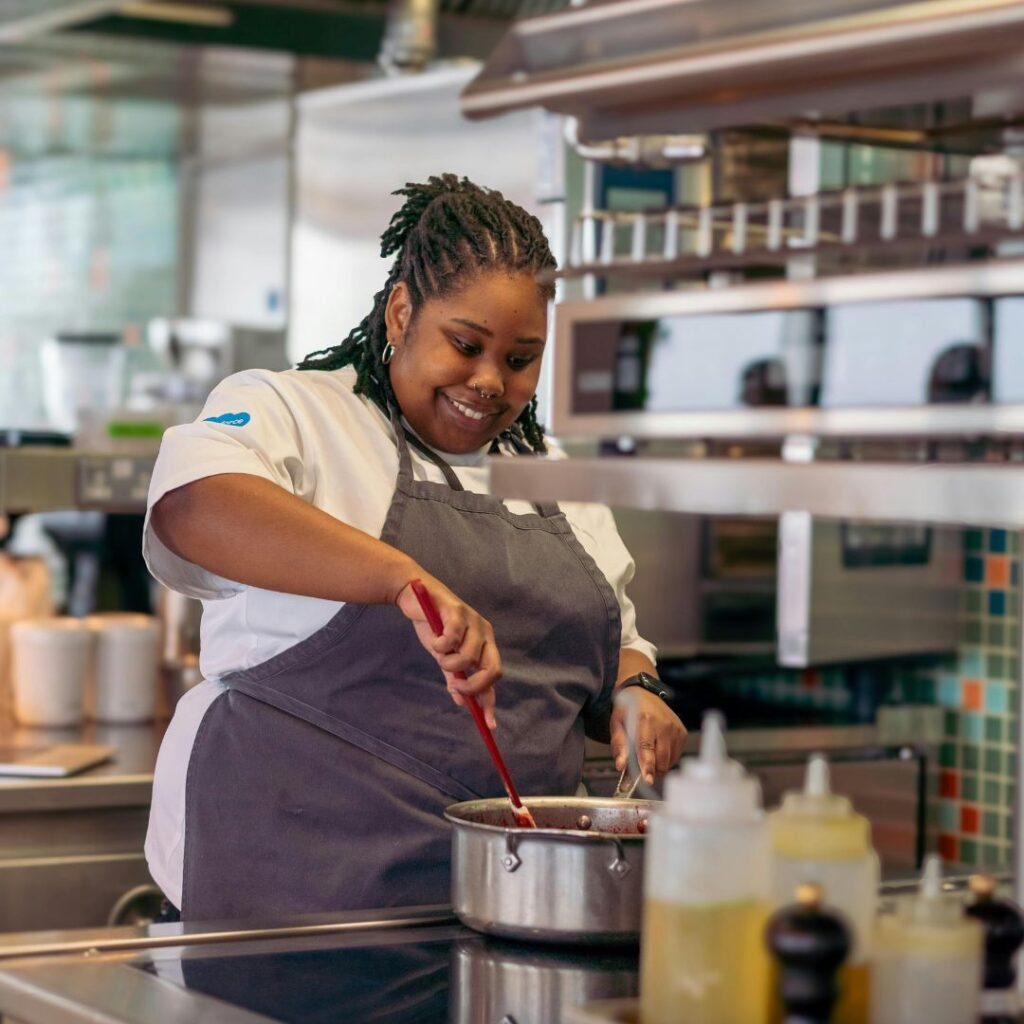 woman cooking in commercial kitchen